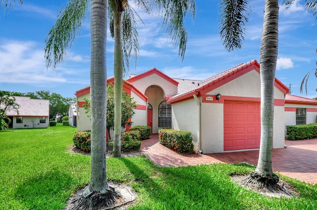7644 Lexington Club Blvd Unit A, Delray Beach, FL 33446 - mediterranean / spanish-style home featuring a garage, stucco siding, a front yard, and decorative driveway