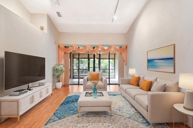 7644 Lexington Club Blvd Unit A, Delray Beach, FL 33446 - living room with light wood-style flooring and rail lighting