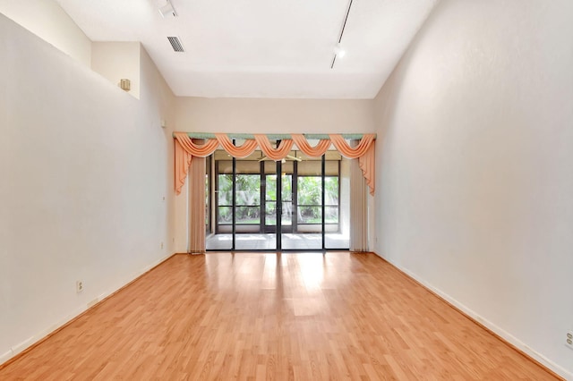 7644 Lexington Club Blvd Unit A, Delray Beach, FL 33446 - unfurnished room with light wood finished floors, baseboards, and attic access
