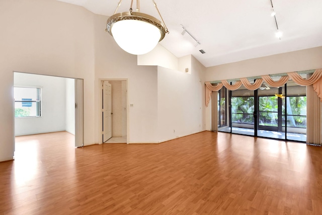 7644 Lexington Club Blvd Unit A, Delray Beach, FL 33446 - spare room featuring track lighting, light wood finished floors, and high vaulted ceiling