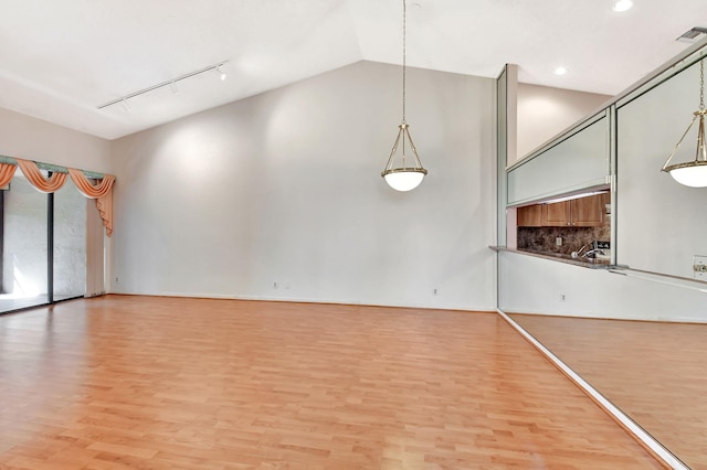 7644 Lexington Club Blvd Unit A, Delray Beach, FL 33446 - unfurnished room with light wood-style floors, track lighting, recessed lighting, and high vaulted ceiling
