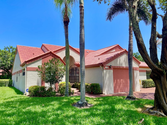 7644 Lexington Club Blvd Unit A, Delray Beach, FL 33446 - view of front of property featuring a tiled roof, an attached garage, stucco siding, and a front yard