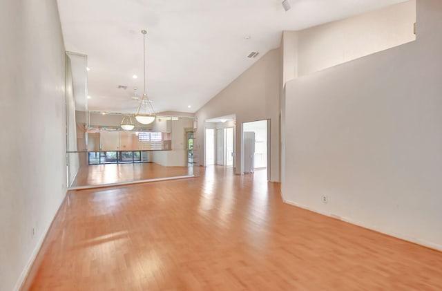 7644 Lexington Club Blvd Unit A, Delray Beach, FL 33446 - unfurnished living room with light wood finished floors, baseboards, and high vaulted ceiling