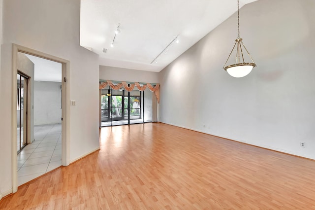 7644 Lexington Club Blvd Unit A, Delray Beach, FL 33446 - unfurnished room featuring rail lighting, light wood-style floors, and baseboards