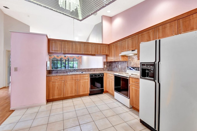 7644 Lexington Club Blvd Unit A, Delray Beach, FL 33446 - kitchen featuring white appliances, under cabinet range hood, a sink, high vaulted ceiling, and backsplash