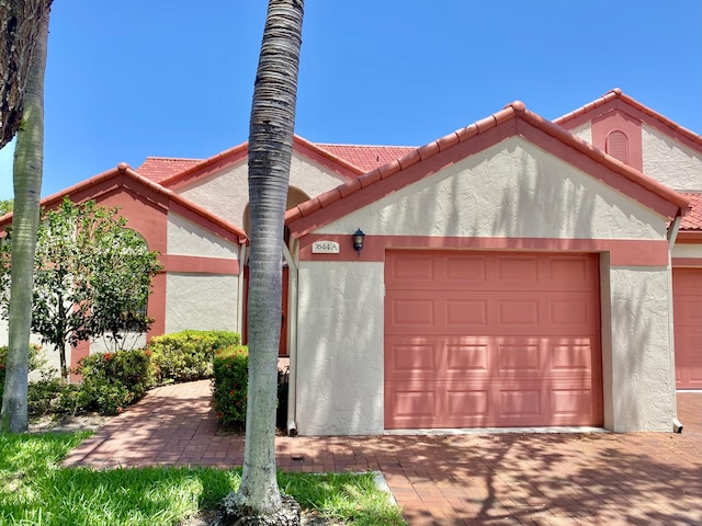 7644 Lexington Club Blvd Unit A, Delray Beach, FL 33446 - garage with decorative driveway