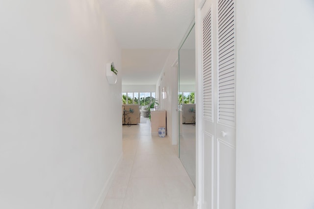 105 NE 19th Ave Unit 356, Deerfield Beach, FL 33441 - hall featuring light tile patterned flooring and baseboards