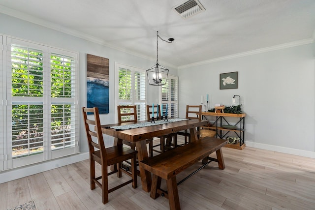 2948 SE Treasure Island Rd, Port Saint Lucie, FL 34952 - dining area with a chandelier, light wood-style floors, crown molding, and baseboards