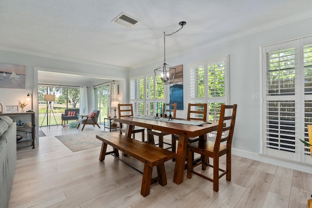 2948 SE Treasure Island Rd, Port Saint Lucie, FL 34952 - dining room with ornamental molding, plenty of natural light, and light wood finished floors