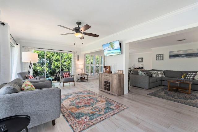 2948 SE Treasure Island Rd, Port Saint Lucie, FL 34952 - living room with a ceiling fan, healthy amount of natural light, light wood-type flooring, and crown molding