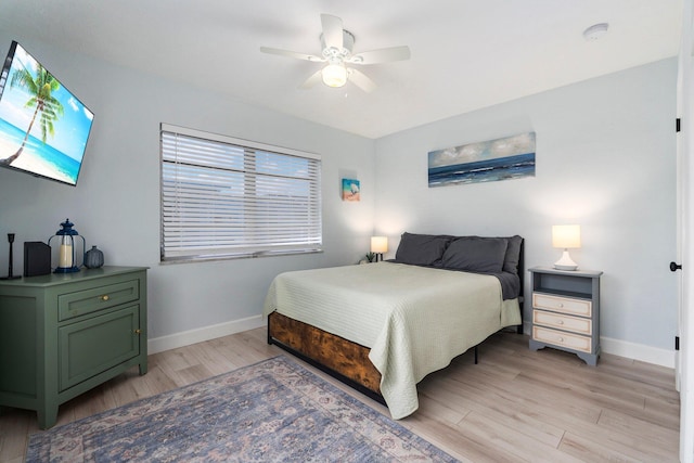 2948 SE Treasure Island Rd, Port Saint Lucie, FL 34952 - bedroom featuring light wood-type flooring, baseboards, and a ceiling fan