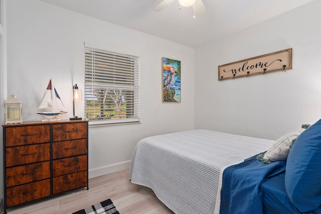 2948 SE Treasure Island Rd, Port Saint Lucie, FL 34952 - bedroom featuring wood finished floors, baseboards, and ceiling fan