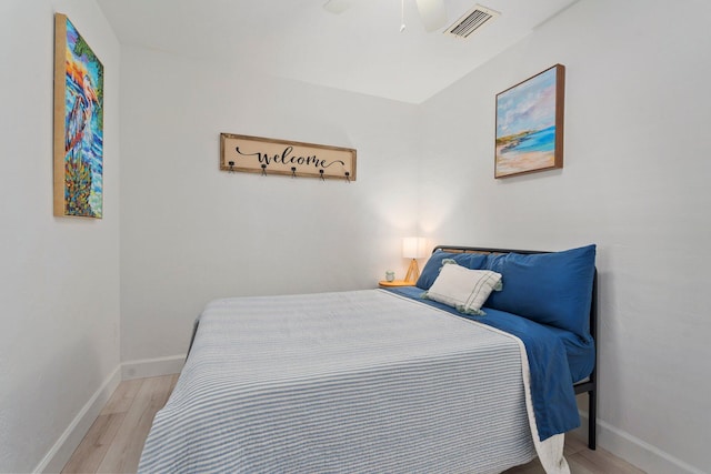 2948 SE Treasure Island Rd, Port Saint Lucie, FL 34952 - bedroom with light wood finished floors, baseboards, and ceiling fan