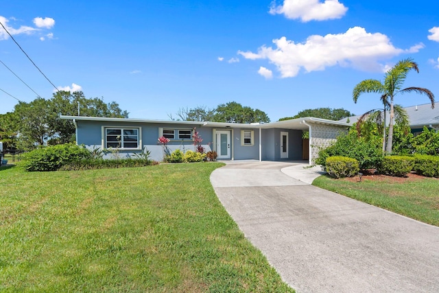 2948 SE Treasure Island Rd, Port Saint Lucie, FL 34952 - single story home featuring concrete driveway, a front yard, an attached carport, and stucco siding