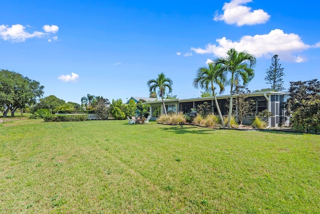 2948 SE Treasure Island Rd, Port Saint Lucie, FL 34952 - view of green lawn with a sunroom