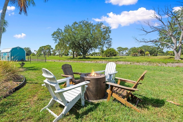 2948 SE Treasure Island Rd, Port Saint Lucie, FL 34952 - view of grassy yard featuring a fire pit, a view of rural / pastoral area, and an outdoor structure