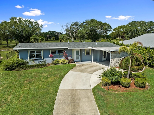 2948 SE Treasure Island Rd, Port Saint Lucie, FL 34952 - ranch-style home with concrete driveway, an attached carport, and stucco siding