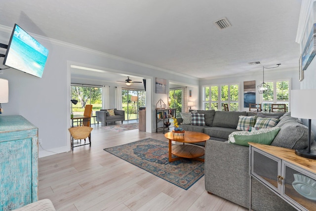 2948 SE Treasure Island Rd, Port Saint Lucie, FL 34952 - living area featuring plenty of natural light, ornamental molding, light wood finished floors, and ceiling fan