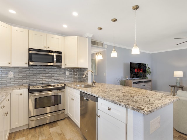 540 Flanders L, Delray Beach, FL 33484 - kitchen with appliances with stainless steel finishes, a sink, a peninsula, decorative backsplash, and crown molding