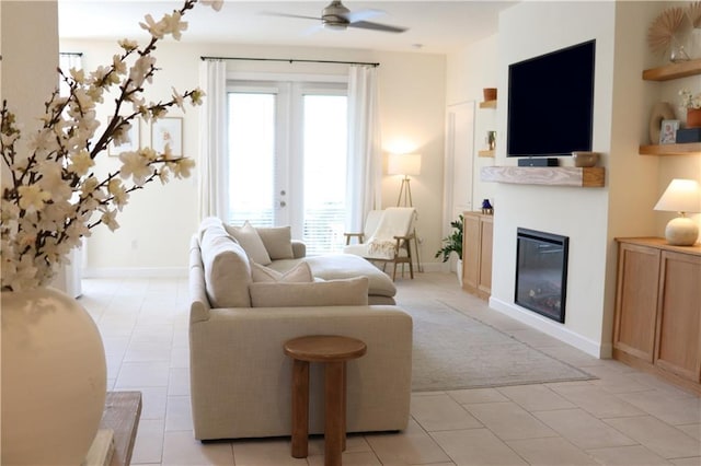 1095 N Verona Trace Dr, Vero Beach, FL 32966 - living area with a ceiling fan, a glass covered fireplace, light tile patterned floors, and light carpet