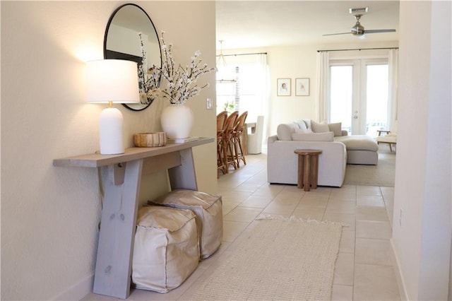 1095 N Verona Trace Dr, Vero Beach, FL 32966 - living room featuring healthy amount of natural light, ceiling fan, light tile patterned floors, and baseboards
