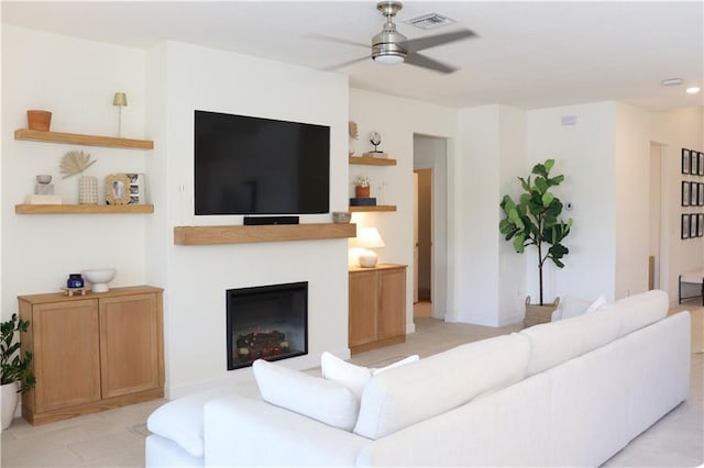 1095 N Verona Trace Dr, Vero Beach, FL 32966 - living area with a ceiling fan, light tile patterned floors, and a glass covered fireplace