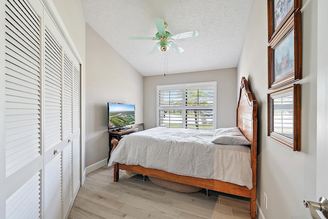 407 SE Duff Ct, Port Saint Lucie, FL 34984 - bedroom featuring a textured ceiling, light wood finished floors, a closet, baseboards, and a ceiling fan