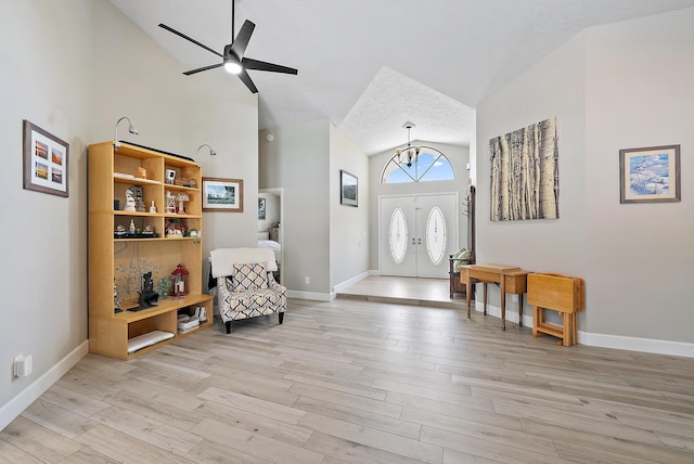 407 SE Duff Ct, Port Saint Lucie, FL 34984 - entryway featuring a chandelier, light wood finished floors, high vaulted ceiling, ceiling fan, and baseboards