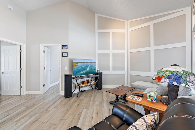 407 SE Duff Ct, Port Saint Lucie, FL 34984 - living area featuring wood finished floors, high vaulted ceiling, and baseboards