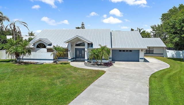 407 SE Duff Ct, Port Saint Lucie, FL 34984 - view of front of house featuring concrete driveway, a garage, and metal roof