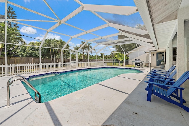 407 SE Duff Ct, Port Saint Lucie, FL 34984 - view of swimming pool with a fenced backyard, a patio area, area for grilling, and a lanai