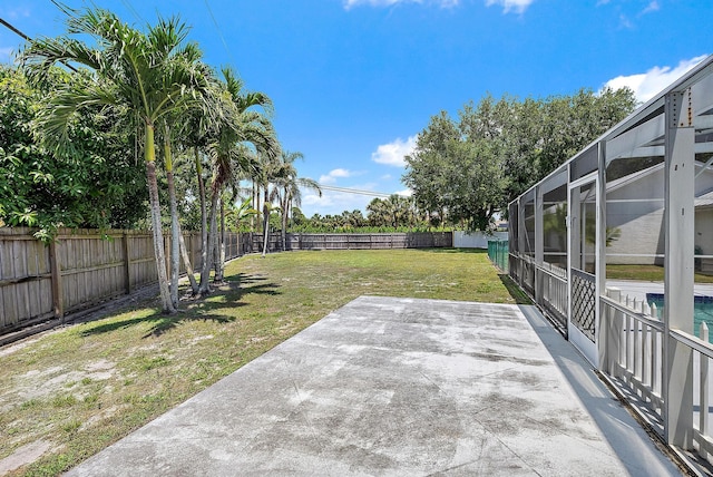 407 SE Duff Ct, Port Saint Lucie, FL 34984 - view of yard featuring a patio and glass enclosure