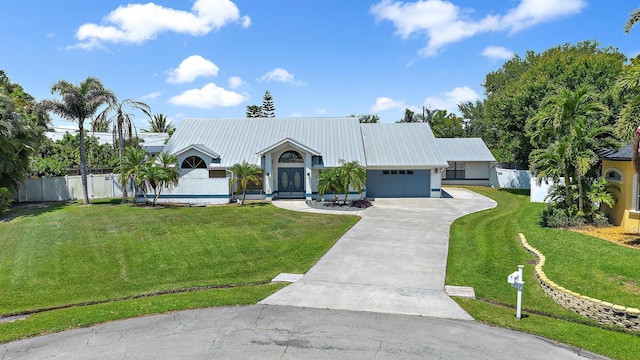 407 SE Duff Ct, Port Saint Lucie, FL 34984 - view of front of property with a garage, concrete driveway, and metal roof