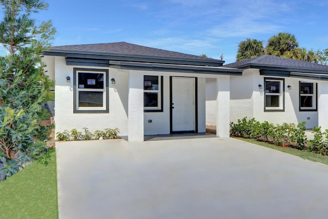 2921 Saginaw Ave Unit 1, West Palm Beach, FL 33417 - prairie-style house featuring stucco siding and roof with shingles