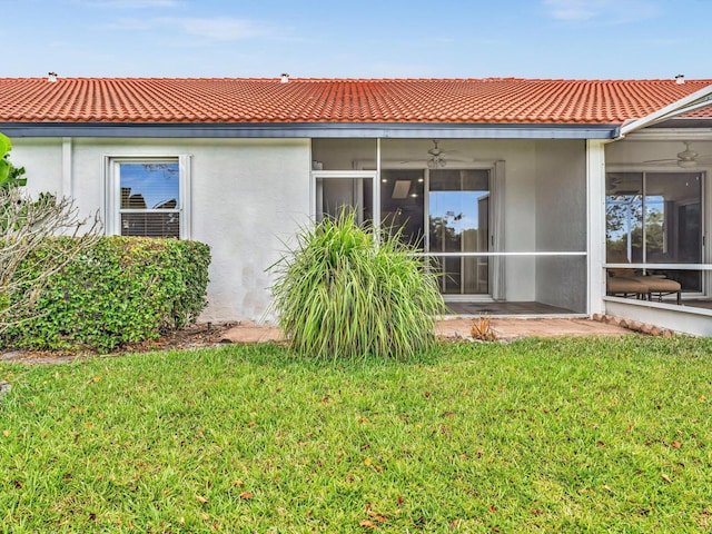 18458 Via Di Sorrento, Boca Raton, FL 33496 - rear view of house with stucco siding, a tiled roof, and a lawn