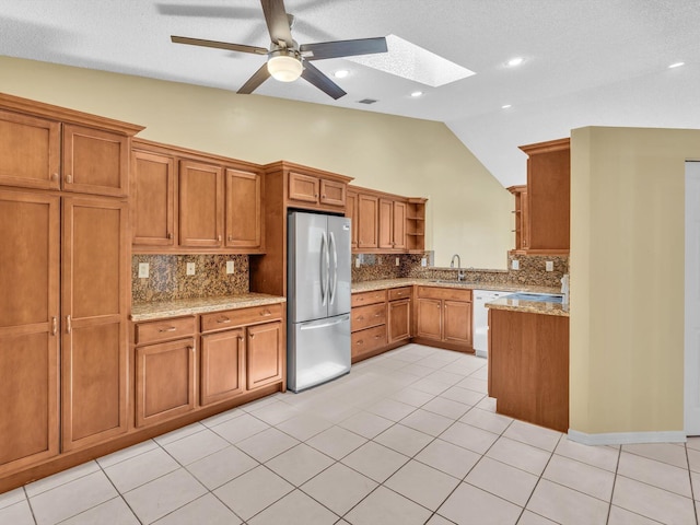 18458 Via Di Sorrento, Boca Raton, FL 33496 - kitchen with freestanding refrigerator, open shelves, a sink, brown cabinets, and high vaulted ceiling