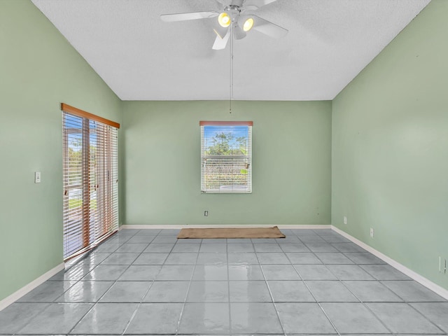 18458 Via Di Sorrento, Boca Raton, FL 33496 - empty room featuring plenty of natural light, ceiling fan, a textured ceiling, light tile patterned floors, and baseboards