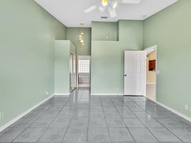 18458 Via Di Sorrento, Boca Raton, FL 33496 - tiled spare room featuring high vaulted ceiling, a ceiling fan, and baseboards