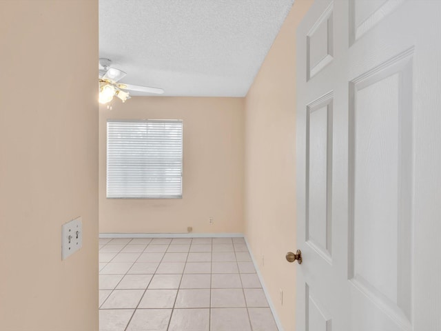 18458 Via Di Sorrento, Boca Raton, FL 33496 - spare room featuring a ceiling fan, a textured ceiling, light tile patterned floors, and baseboards
