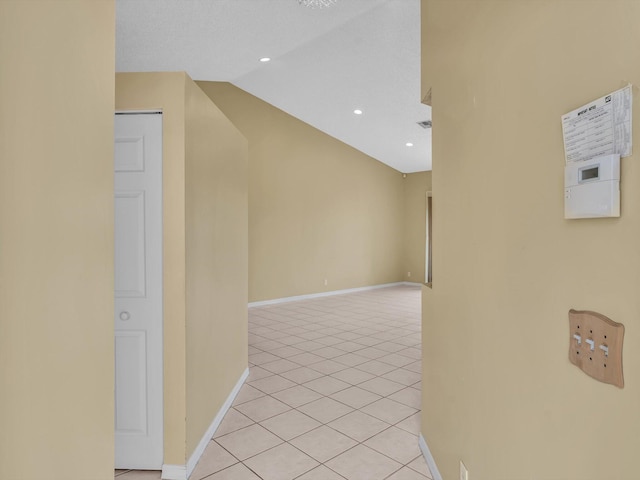 18458 Via Di Sorrento, Boca Raton, FL 33496 - corridor featuring light tile patterned floors, baseboards, vaulted ceiling, and recessed lighting