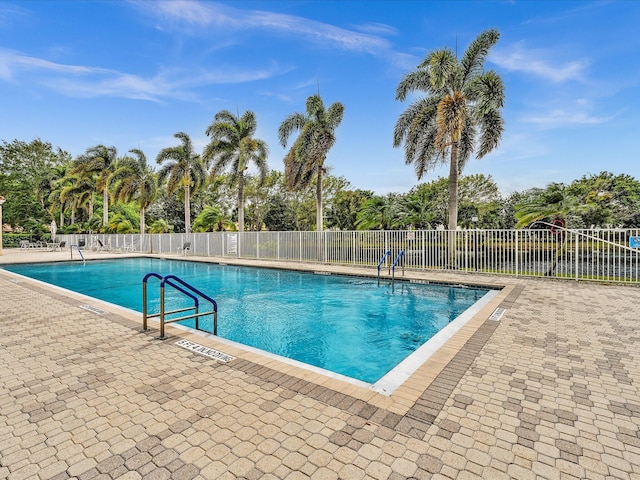 18458 Via Di Sorrento, Boca Raton, FL 33496 - community pool featuring a patio area and view of wooded area