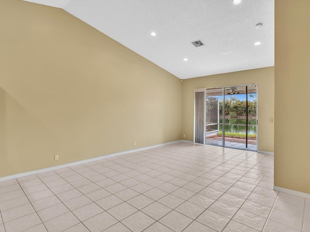 18458 Via Di Sorrento, Boca Raton, FL 33496 - spare room featuring vaulted ceiling, recessed lighting, baseboards, a textured ceiling, and light tile patterned floors