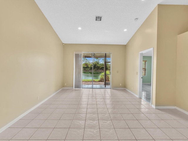 18458 Via Di Sorrento, Boca Raton, FL 33496 - unfurnished room featuring light tile patterned flooring, baseboards, recessed lighting, and a textured ceiling