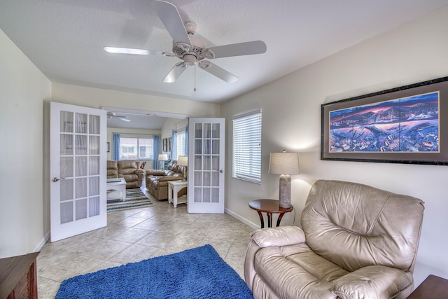 188 Wandering Trl, Jupiter, FL 33458 - sitting room featuring french doors, a ceiling fan, baseboards, and light tile patterned flooring