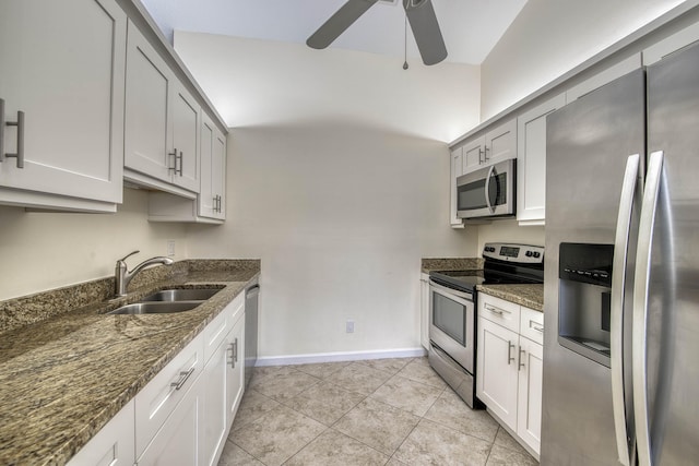188 Wandering Trl, Jupiter, FL 33458 - kitchen with stainless steel appliances, a sink, a ceiling fan, dark stone counters, and light tile patterned floors