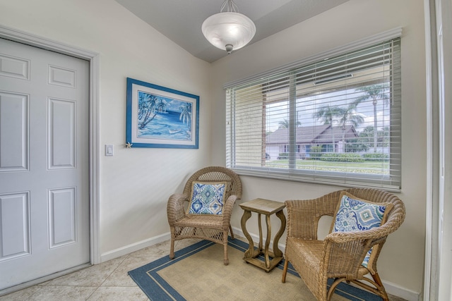 188 Wandering Trl, Jupiter, FL 33458 - sitting room with baseboards, light tile patterned floors, and lofted ceiling