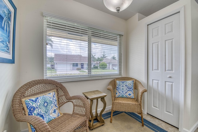 188 Wandering Trl, Jupiter, FL 33458 - living area with healthy amount of natural light, baseboards, and light tile patterned floors
