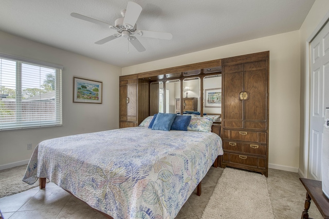 188 Wandering Trl, Jupiter, FL 33458 - bedroom with light tile patterned floors, baseboards, and a ceiling fan