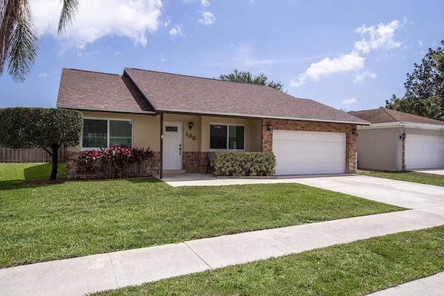 188 Wandering Trl, Jupiter, FL 33458 - single story home with a garage, a front yard, concrete driveway, a shingled roof, and stucco siding
