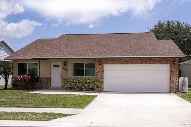 188 Wandering Trl, Jupiter, FL 33458 - view of front of property with roof with shingles, concrete driveway, a garage, and a front lawn